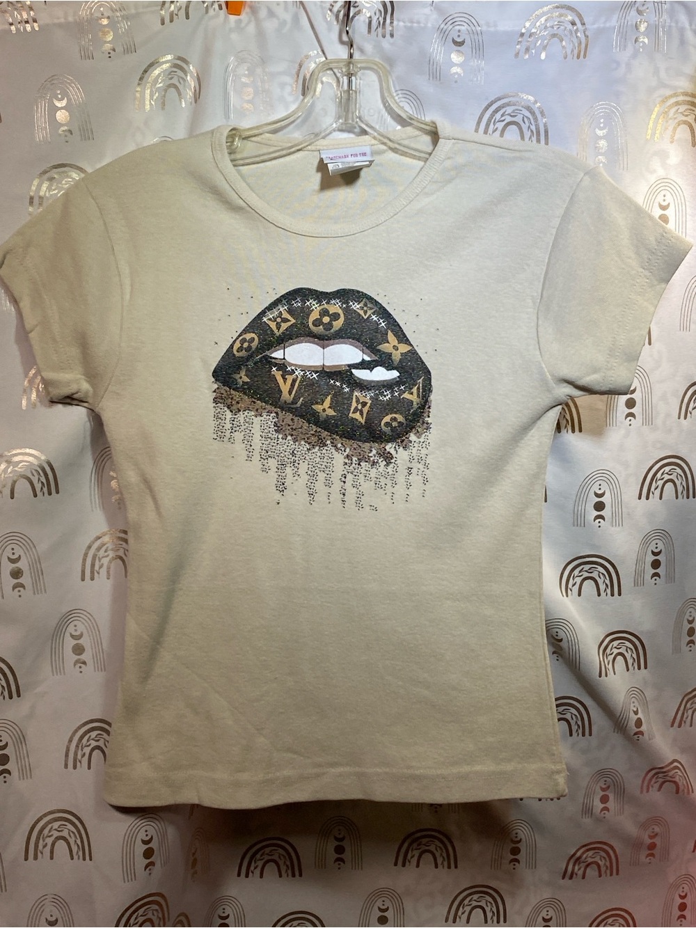 Cream Short Sleeve Tee with Metallic Logo Lip Graphic. LV INSPO